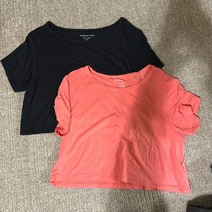 small loose cropped American Eagle tops in black and pink